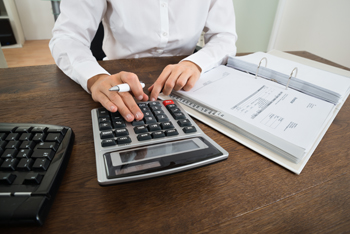 Businessperson Calculating Financial Expenses